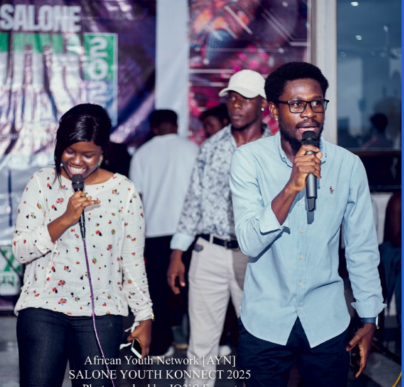 Two young hosts speaking into microphones at Salone Youth Konnect 2025