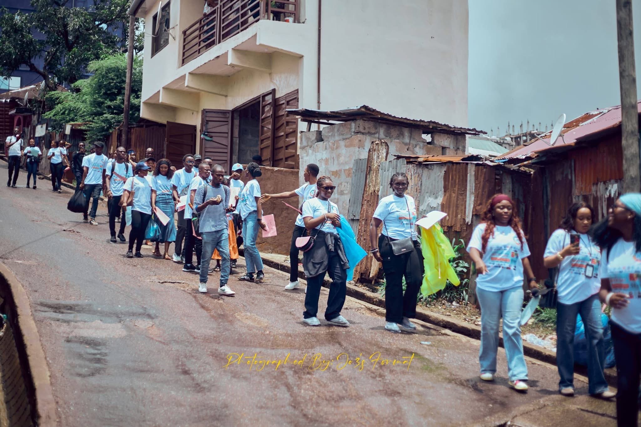 Youth advocates marching through the community in IYD t-shirts during the outreach